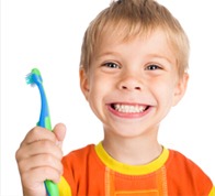 Smiling boy holding a toothbrush