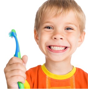 Smiling boy holding a toothbrush
